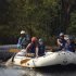 Group enjoying a thrilling whitewater rafting experience in the scenic forests of Dandeli, India.